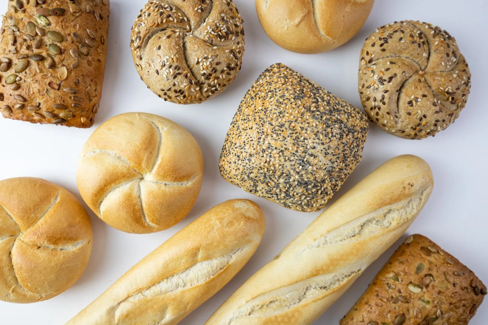 A flat lay of various freshly baked breads showcasing texture and variety.